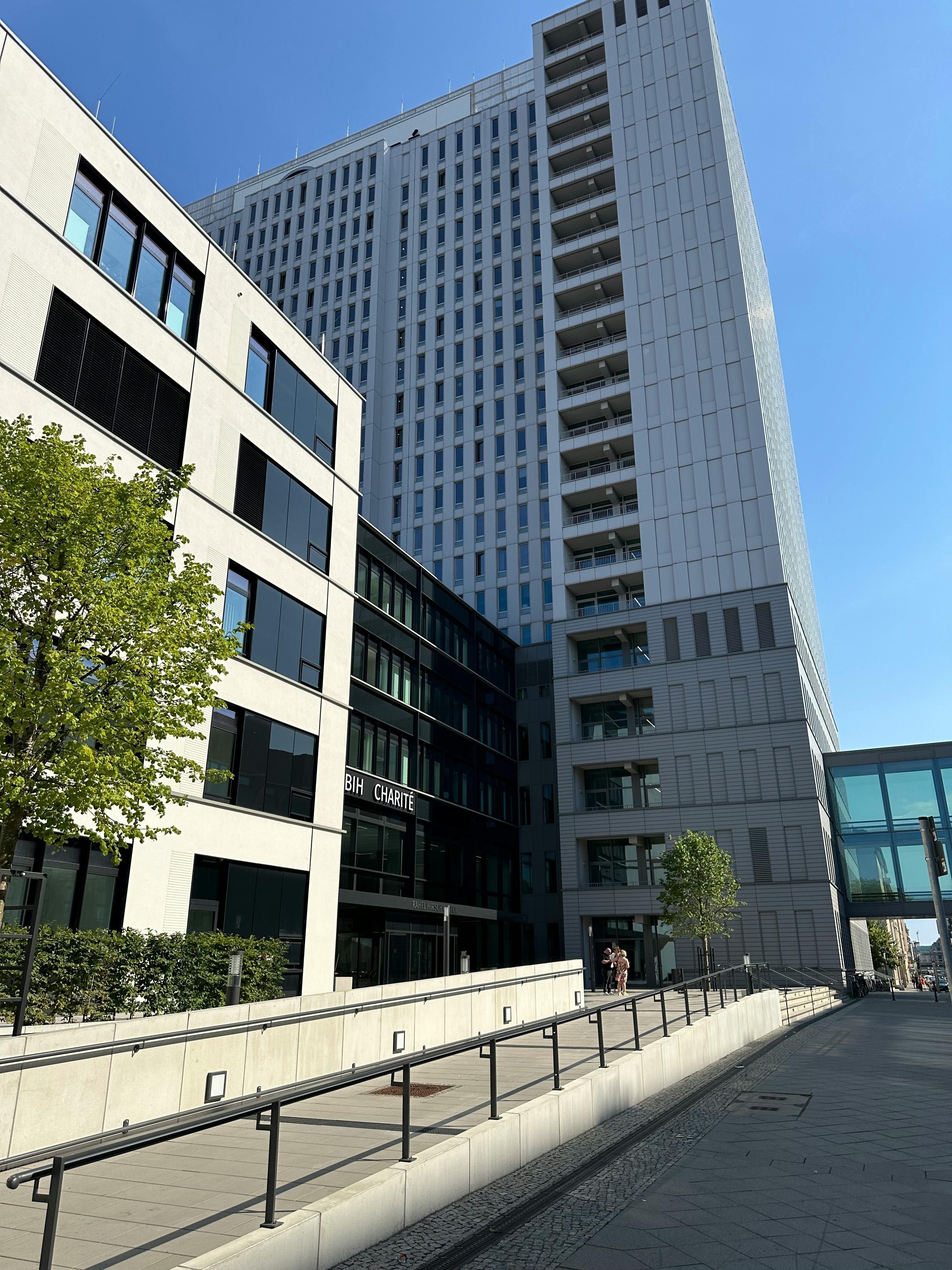 Contemporary buildings of Charité University Hospital in Berlin, Germany, under clear blue skies.